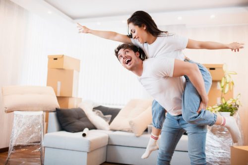 happy-husband-wife-have-fun-swirl-sway-relocating-own-apartment-together-relocation-concept-overjoyed-young-couple-dance-living-room-near-cardboard-boxes-entertain-moving-day